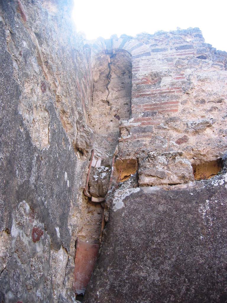 V.1.30 Pompeii. July 2007. 
Arched niche latrine on upper floor in south-east corner. Photo courtesy of Barry Hobson.
