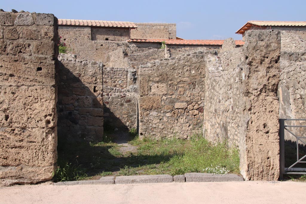 V.2.6 Pompeii. October 2023. Looking north towards entrance doorway to shop. Photo courtesy of Klaus Heese.