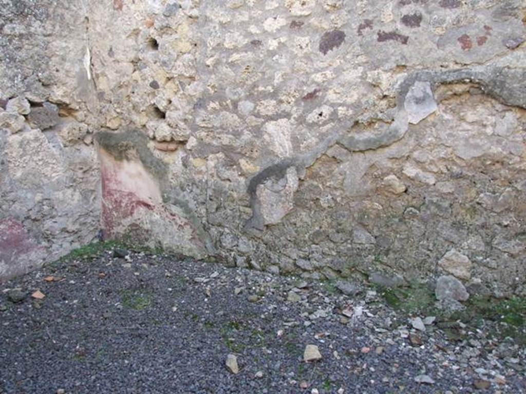 V.2.15 Pompeii. December 2007. Room 5, south-west corner. According to NdS, this room in the south-west corner of the peristyle, was a storeroom. It had white plastered walls and purple dado, and was linked with room 4. Perhaps originally it had been a cubiculum but then had been transformed into a storeroom. This was apparent from the holes, drilled in the walls, for shelves.
