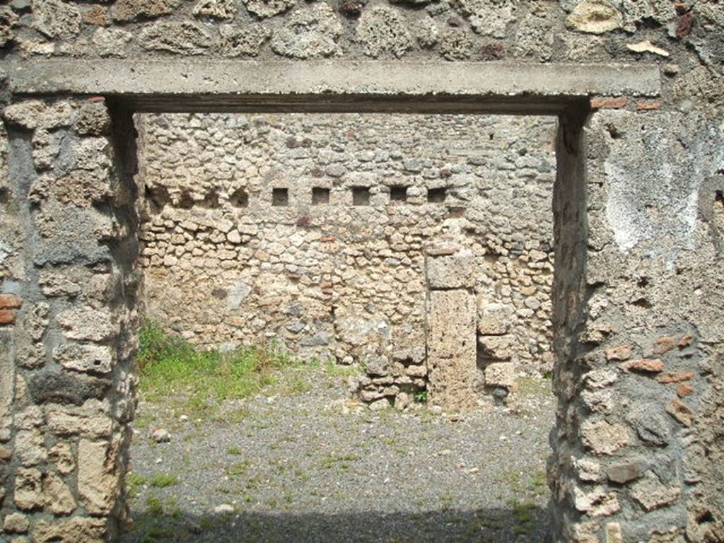 V.2.f  Pompeii. May 2005. Entrance, looking east. According to NdS, the atrium was devoid of an impluvium, but to the right of where one entered was a small hearth. Above the hearth was a semicircular niche and a short distance away, in the south-west corner of the atrium, was a latrine which would have been protected by a lean-to roof. See Notizie degli Scavi, 1896, (p.436. See Mau in BdI, VIII, 1893, (p.7-9)
According to Boyce, just to the right of the entrance against the west wall in the atrium stood a low masonry altar. Traces of fire were seen on the top of the altar when it was first excavated. Above the altar was an arched niche in the wall.
When Boyce wrote (1937) he said the last layer of plain white stucco has fallen from the interior walls, revealing a finer layer beneath it This was white and decorated with red spots. Not photographed yet, it may not be still there. See Boyce G. K., 1937. Corpus of the Lararia of Pompeii. Rome: MAAR 14. (p.36, 103)
According to Giacobello, the hearth was located near the niche in the south corner of the atrium. On the same west wall, to the left of the Lararium is a second smaller niche, and also a trace of a third niche to the left again. See Giacobello, F., 2008. Larari Pompeiani: Iconografia e culto dei Lari in ambito domestico.  Milano: LED Edizioni. (p.164 with photo).
