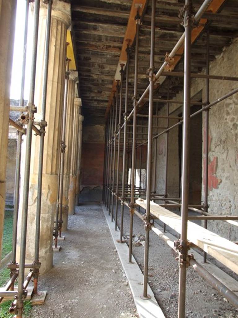 V.2.i Pompeii. December 2007. 
Room 23, looking west along north side of Rhodian peristyle towards doorway to kitchen, in centre.  
