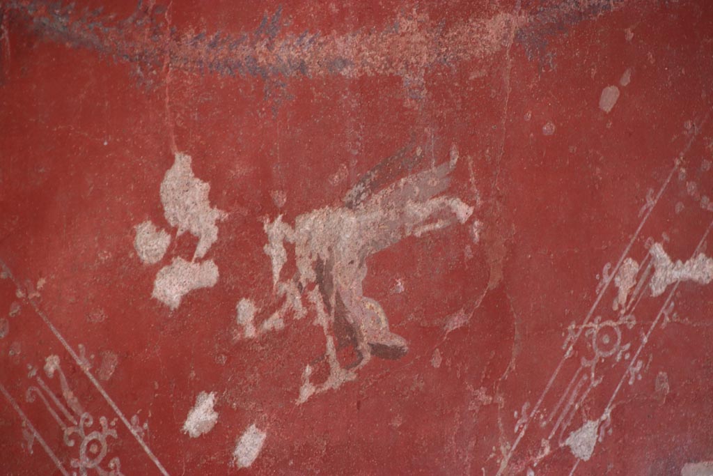 V.2.i Pompeii.  October 2023. Tablinum 7, detail of painted zoccolo on red central panel of lower west wall. Photo courtesy of Klaus Heese.