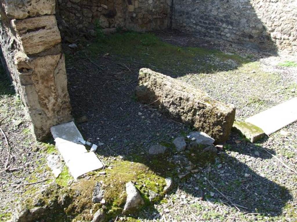 V.3.4 Pompeii. March 2009. Remains of marble threshold or sill of small doorway between two joined rooms. The wider marble threshold, on the right, connected from the west portico into the second room.
