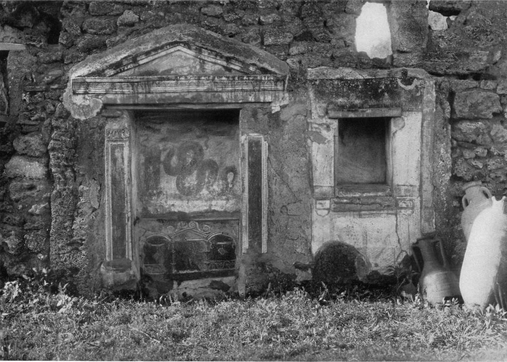 V.3.7 Pompeii. c.1930s. West wall of garden area. Large aedicula lararium and small niche on the right.
See Boyce G. K., 1937. Corpus of the Lararia of Pompeii. Rome: MAAR 14.  (112, p. 38, Pl 36, 2).

