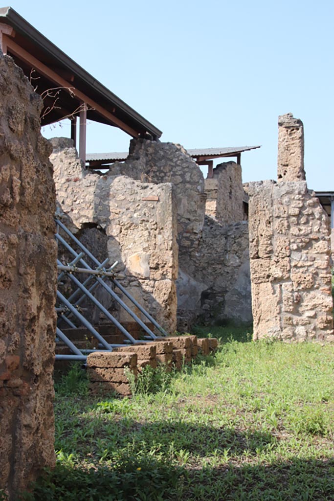 V.3.7 Pompeii. October 2023. 
Looking north across atrium from entrance corridor towards doorway to triclinium. 
Photo courtesy of Klaus Heese.


