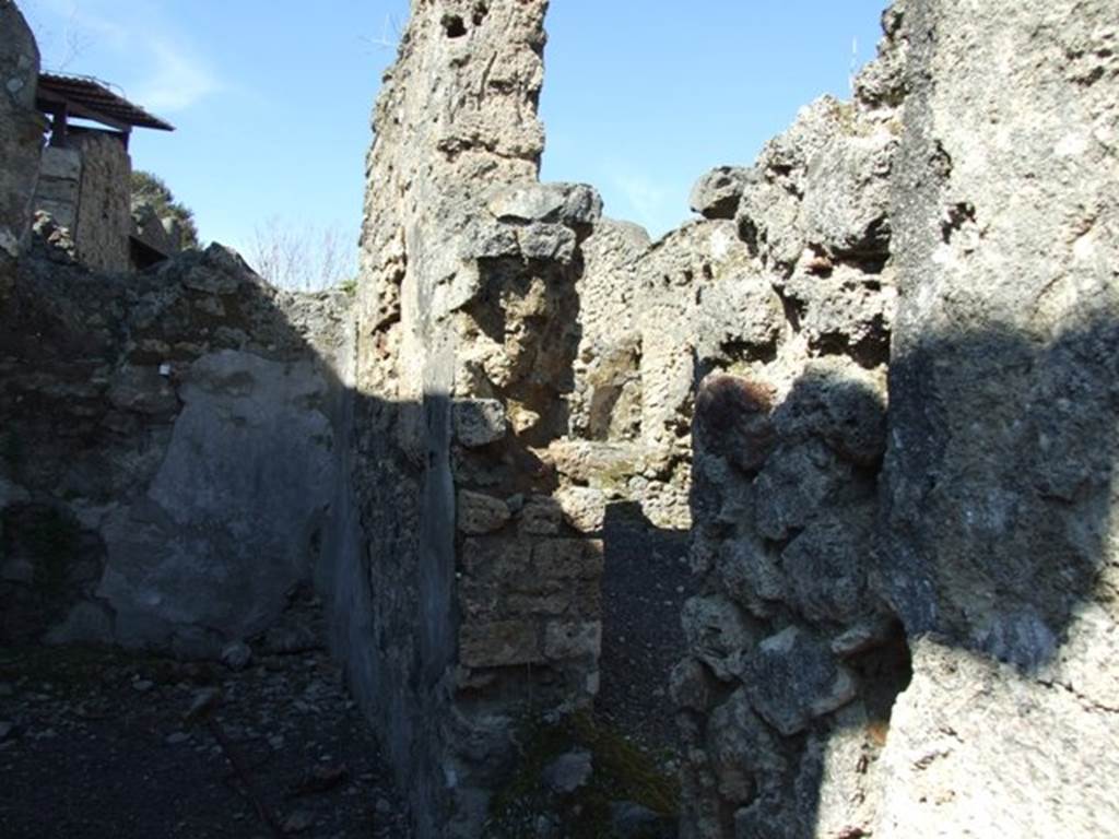 V.3.7 Pompeii.  March 2009. Triclinium.  East wall with door to passageway.