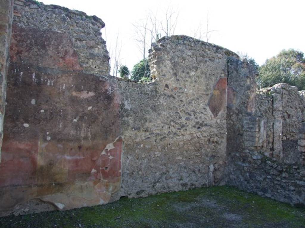V.3.9 Pompeii. March 2009. West wall of atrium, site of two rooms, with window, looking north-west. According to NdS, the large tablinum opposite the entrance doorway on the west side of the atrium, had been divided into two cubicula. The partition wall did not affect the old window in the west wall, which continued to give light to both rooms. The room in the south-west corner kept the entrance doorway from the atrium. From there, one entered into the other room in the north-west corner, which had been separated from the atrium by a wall. Both rooms were decorated with paintings. The one in the south-west, on the left of the photo, showed a dado coloured in yellow with black lines, between the lines were painted plants and long leaves.

In the room in the north-west corner, on the right of the photo, only the back (west) wall was more of less conserved. The dado was painted with red rectangles separated by white bands. The area above the dado was yellow, and separated into three panels by violet bands. The two side panels had a painted garland at the top, and in the middle of the panel, one had a painted swan, the other a panther. The central panel had a large painted candelabra decoration with leaves, and above was a swan with spread wings, all painted to look like bronze. The upper zone of the wall was painted deep red, with a type of pavilion in the centre, and garlands at the sides. The north wall was heavily damaged, and only one figure remained, a painted white stag or deer. On the interior of the two pillars of the original tablinum, in the north-east and south-east corners, two swans were shown with ribbons in their beaks.
See Notizie degli Scavi, 1902, dated November 1901, p.201-203
