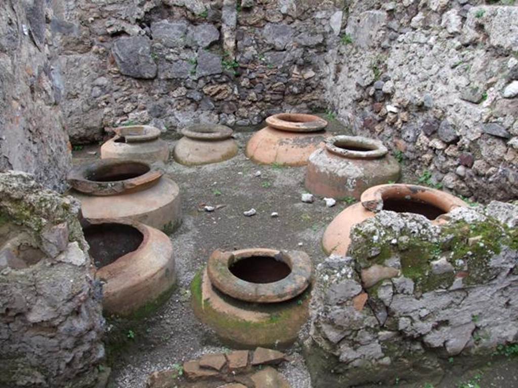 V.4.7 Pompeii. December 2007. Looking west across vinarium in north-west corner, north of doorway at V.4.6, with eight dolia.