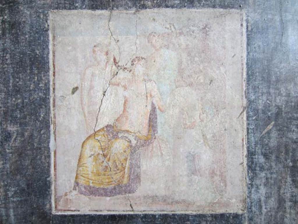 V.4.a Pompeii. March 2012. Cubiculum on south side of atrium, east wall. Wall painting of the Toilet of Venus or the Toilette of Aphrodite. Photo courtesy of Marina Fuxa.
