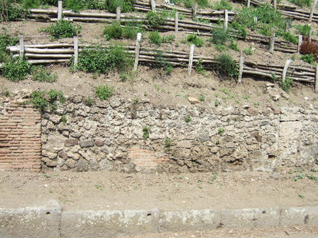 V.6.10 (on left) and V.6.9, Pompeii. May 2006. Unexcavated entrances and facade. On the right is the north boundary V.6.8.