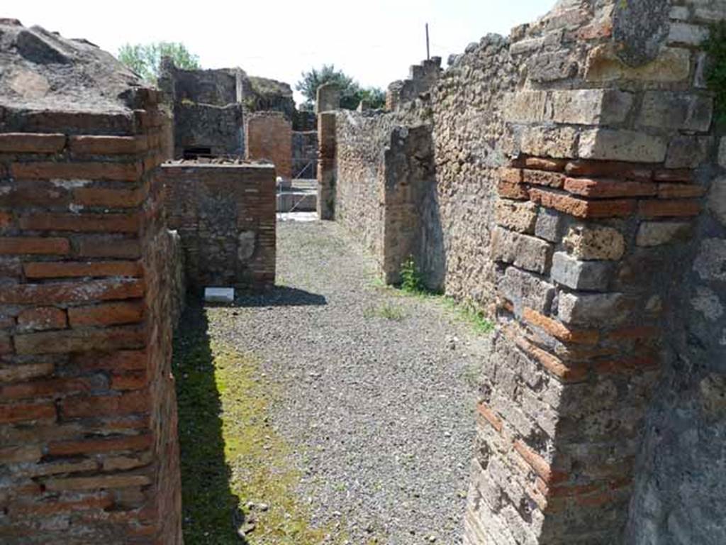 VI.3.10 Pompeii. May 2010. Looking west from yard, along passageway to front of workshop.