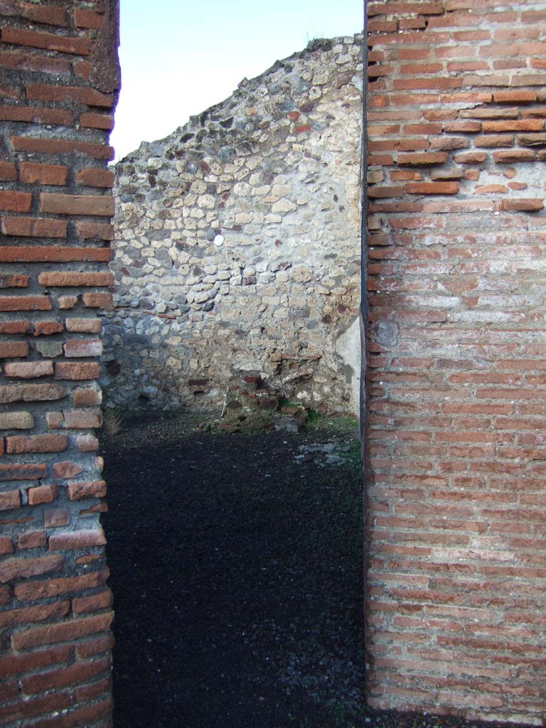 VI.3.19 Pompeii. December 2005. Looking through doorway on west side into VI.3.18.
In the centre against the north wall, can be seen the stairs to the upper floor in VI.3.18.


