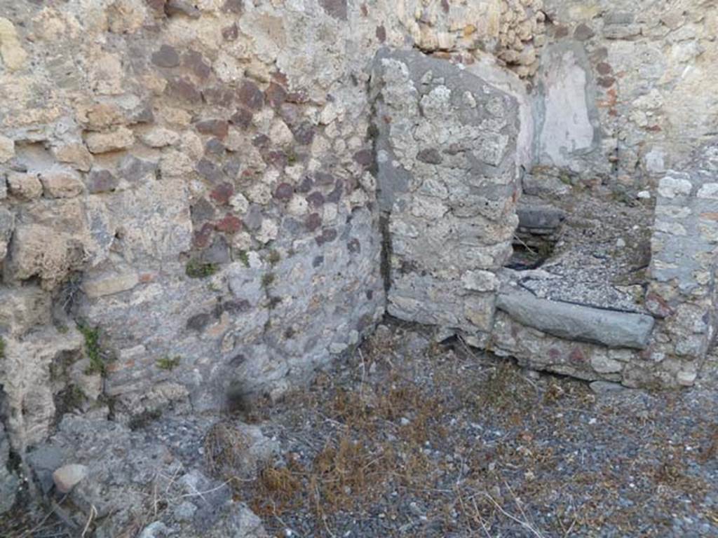 VI.5.9 Pompeii. May 2011. Doorway to latrine/small room in north-east corner of kitchen area.
According to Hobson, “As a result of the lack of preservation of wood in Pompeii, no doors have been found for latrines.
However, a large percentage of latrine rooms have threshold stones which may have grooves into which door posts were set.
Many of the rooms have a step up from the floor of the corridor or outer room.
This not only serves to differentiate the cubicle from other rooms, but also allows for the tile system to drain efficiently under the toilet seat.”
See Hobson, B., 2009. Latrinae et foricae: Toilets in the Roman World. London; Duckworth. (p.82 and fig.105, showing grooves for doorposts).