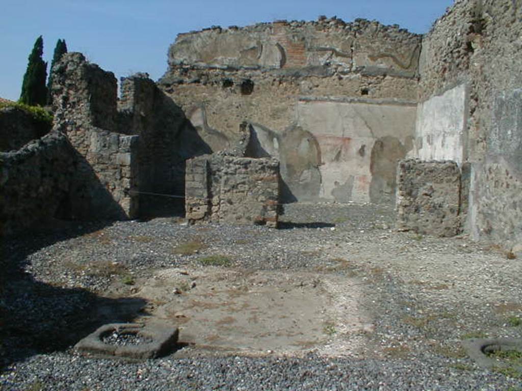 VI.5.13 Pompeii. September 2004. Looking north across atrium towards rear rooms.
According to Bonucci,
“The room on the left would have been a bedroom; the larger one on the right was the tablinum, which was also forced to serve as the dining room, because no other triclinium was found. Found in the tablinum which was paved in mosaic, the remains of a painting representing Phryxus and Helle, above two figures, one standing the other seated, and higher still a pretty stucco moulding”.
See Bonucci, C, 1827. Pompei descritta, p. 103.
According to Breton, “At the rear of the tablinum, paved in mosaic, was an almost erased painting which represented Phryxus and Helle”.
See Breton, Ernest. 1855. Pompeia, decrite et dessine: Seconde edition . Paris, Baudry, p. 256-7.
According to Fiorelli, found in the atrium were two paintings.
One showed Ulysses and Circe, the other Achilles being recognised by Ulysses at the court of Lycomedes.
In the tablinum, two badly damaged paintings were found. One of Phryxus and Helle, the other of Adonis wounded.
There were also figures in the middle of the ornately painted architecture, Helbig’s numbers 979, 994, 1001.
See Pappalardo, U., 2001. La Descrizione di Pompei per Giuseppe Fiorelli (1875). Napoli: Massa Editore. (p54)
According to Helbig, found in the atrium were Odysseus (Ulysses) and Circe (1329), Achilles at Skyros, (1299), and Seasons (979, 994 and 1001)
In the tablinum, Phryxus 1252, and Adonis, 343, were found, and above was Hermes 360b,
See Helbig, W., 1868. Wandgemälde der vom Vesuv verschütteten Städte Campaniens. Leipzig: Breitkopf und Härtel.
According to Jashemski, Fiorelli thought that the atrium had a space in the middle for growing plants.
She said that Overbeck-Mau thought the planting beds were in the top of a low wall that enclosed the implvium.
There were two cistern mouths near the impluvium.
See Jashemski, W. F., 1993. The Gardens of Pompeii, Volume II: Appendices. New York: Caratzas. (p.126)