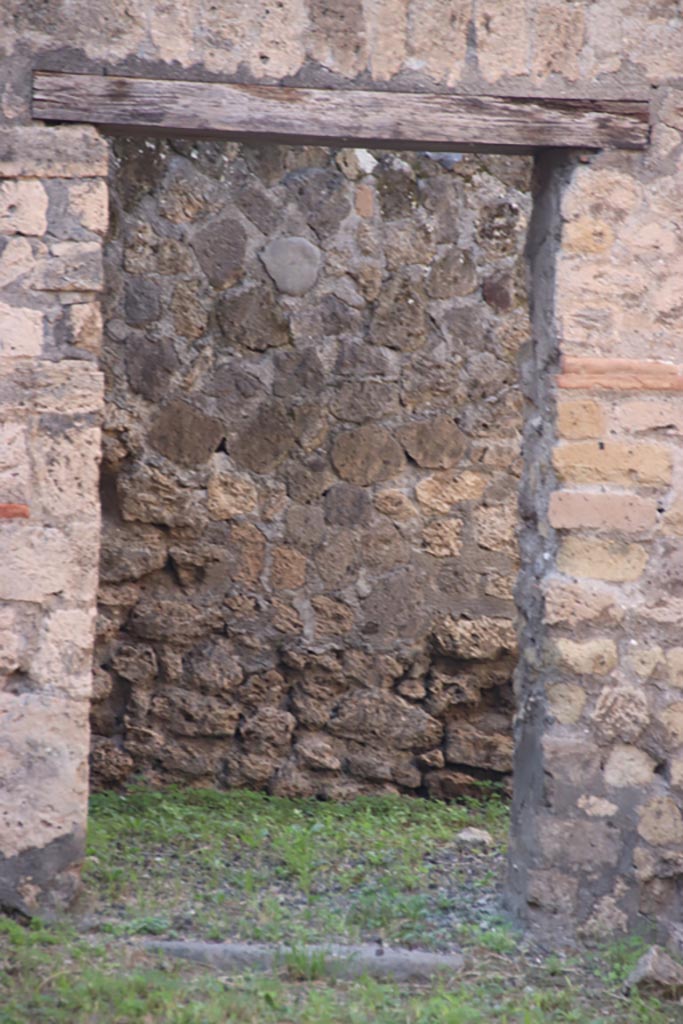 VI.7.15 Pompeii. October 2022.
Doorway in west wall into a rear room. Photo courtesy of Klaus Heese.
