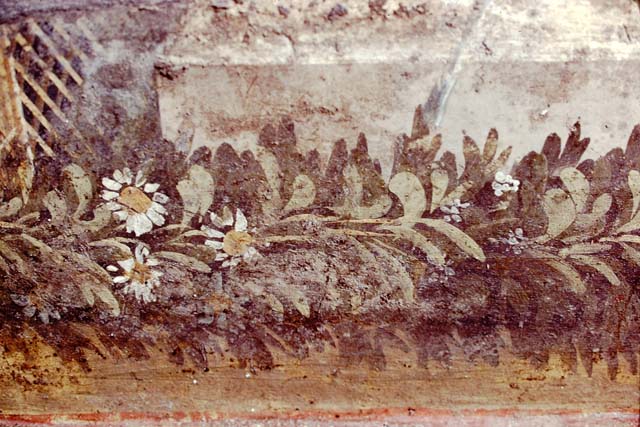 VI.7.23 Pompeii, 1983. Detail of remaining coloured painted plaster and trellis, from west side of south wall behind fountain.  
Source: The Wilhelmina and Stanley A. Jashemski archive in the University of Maryland Library, Special Collections (See collection page) and made available under the Creative Commons Attribution-Non Commercial License v.4. See Licence and use details.
J80f0551
