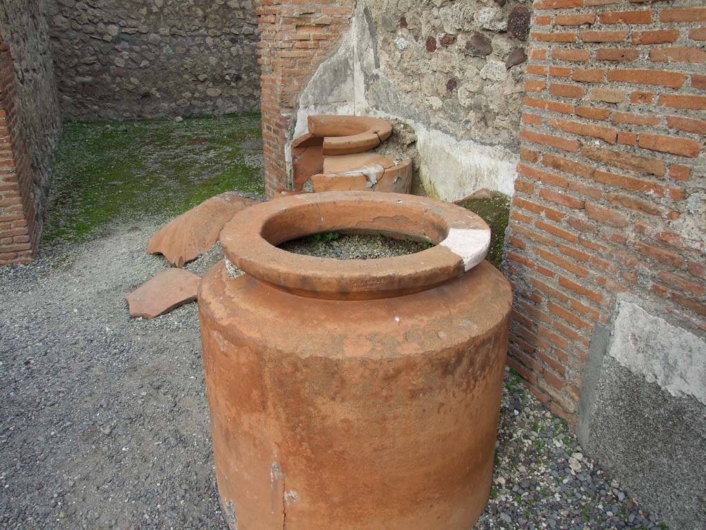 VI.8.9 Pompeii. December 2007. Remains of four dolia against the east wall in the north-east corner of the thermopolium.