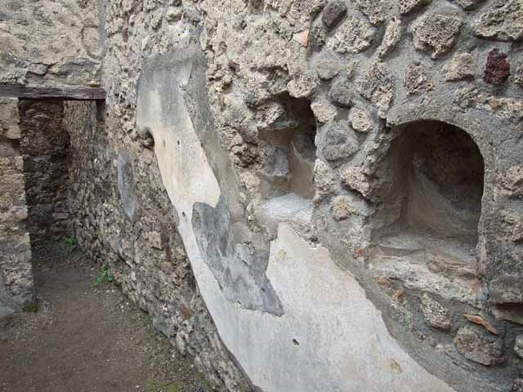 VI.8.14 Pompeii. May 2010. North wall with niches. Looking west to rear room.