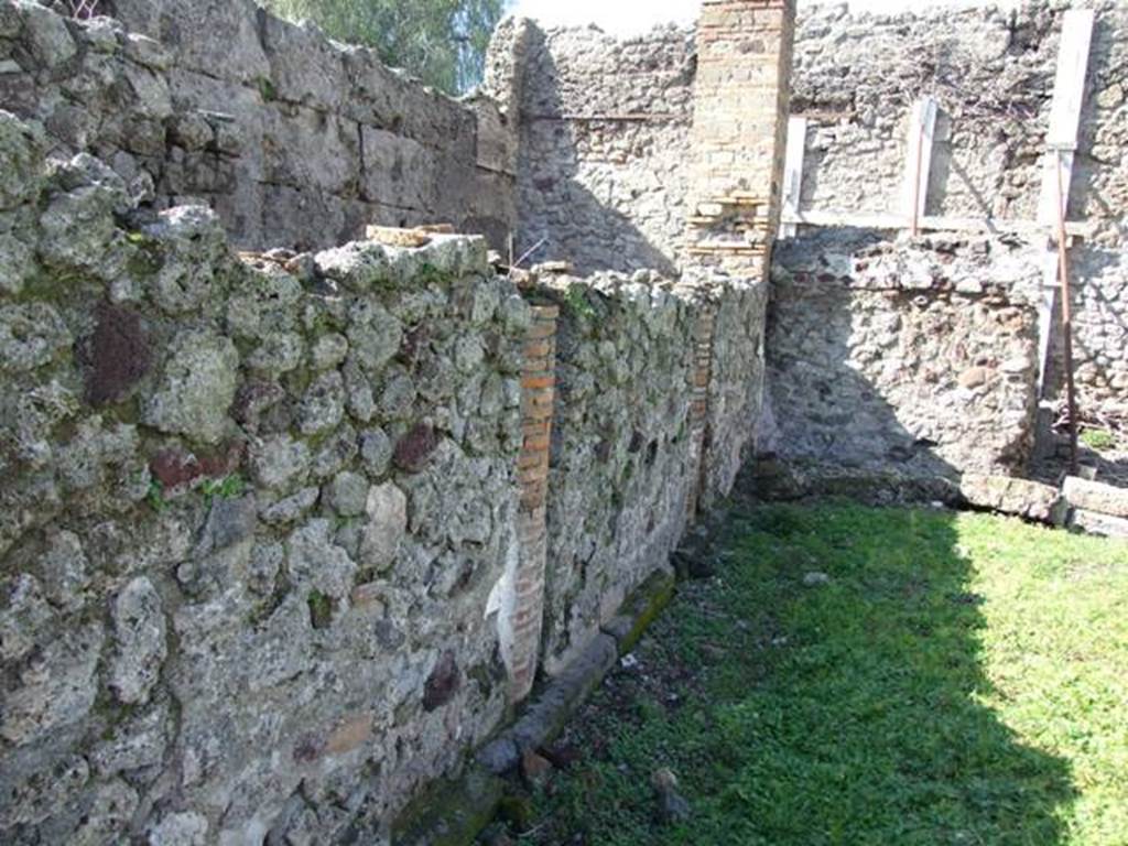 VI.8.20 Pompeii.  March 2009.  Looking north along west side of peristyle. The columns have been filled in with walls. 