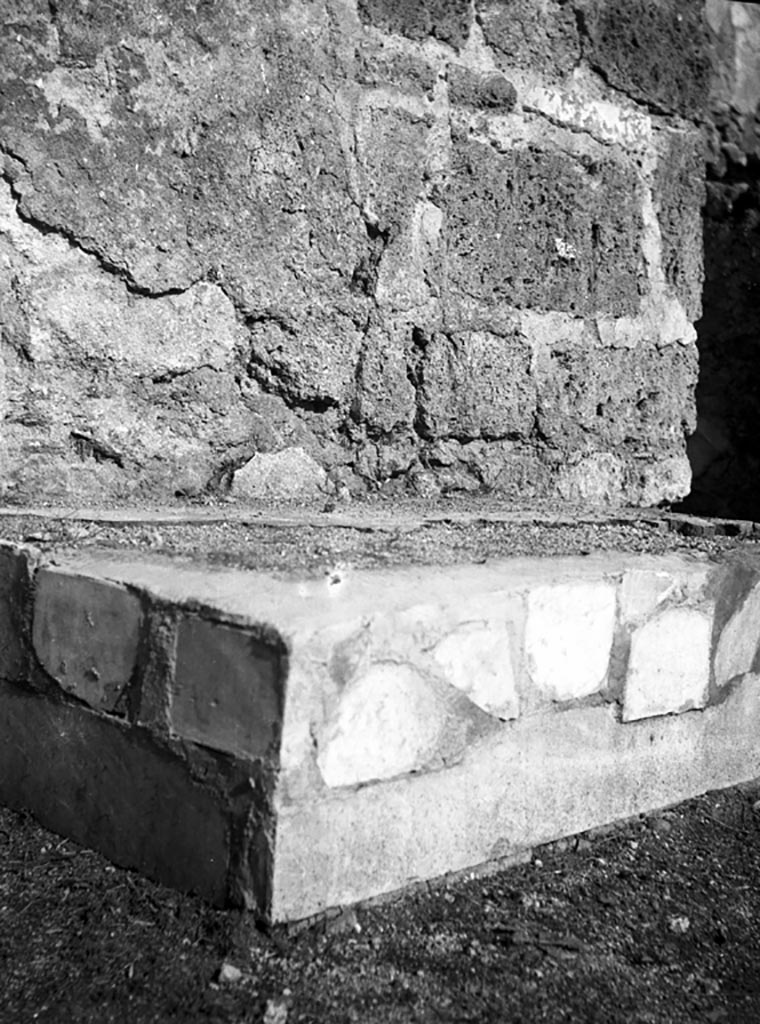 VI.9.3 Pompeii. W681. Base for arca or money-chest against north wall of atrium.
Photo by Tatiana Warscher. Photo © Deutsches Archäologisches Institut, Abteilung Rom, Arkiv.
According to Pernice, in the atrium, between the 1st and 2nd doors, there is a bricked-up pedestal with marble slabs of 1.26 : 0.78 : 0.32. 
The pedestal was bricked up before the later wall stucco was applied (as in the Vettii house). 
The marble slab was restored once and the whole base seems to have been raised. 
On the left and front sides, one notices cutouts in the lower marble slabs which, as they were intended for feet, have become useless due to the slabs placed above them. 
On the right narrow side, the cut-out slab has been pushed upwards during the restoration (0verbeck a. a. 0 . p. 331 ).
See Pernice, E., 1932. Hellenistische Tische, Zisternenmündungen, Beckenuntersätze, Altäre u. Truhen. Berlin, p. 75, n. 21.
Thanks to Espen B. Andersson for assisting us in our interest in money-chests.


