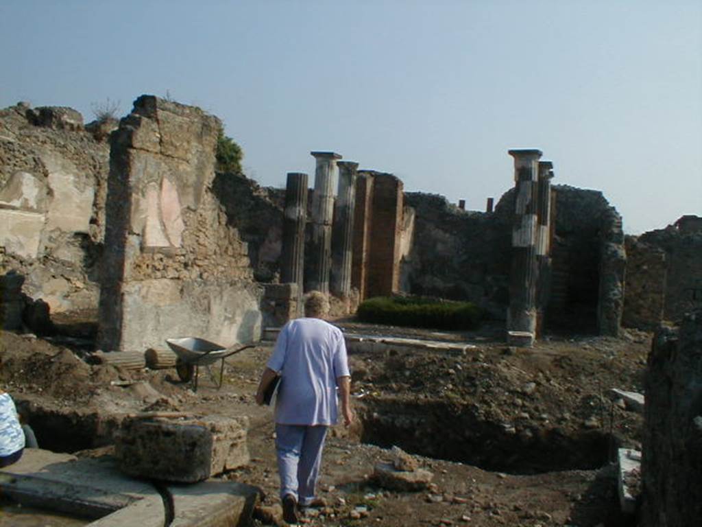 VI.9.3 Pompeii. September 2004. Looking east across rear of atrium, towards remains of tablinum. The north wall of the tablinum is still standing, although much damage was done by the bombing in the night of 16th September 1943. The atrium was hit by the bomb resulting in the demolition and destruction of three rooms in the north-east corner of it.
The IV style wall paintings in the rooms on the north-east side of the atrium were lost. See Garcia y Garcia, L., 2006. Danni di guerra a Pompei. Rome: L’Erma di Bretschneider. (p.79)

