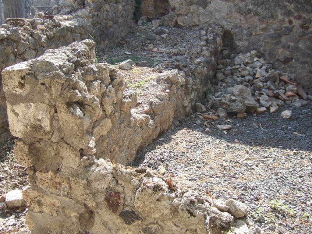 VI.9.3 Pompeii. September 2005. Room 36, south-east corner and south wall of storeroom at rear of kitchen. On the left can be seen the site of the stairs to the upper floor.

