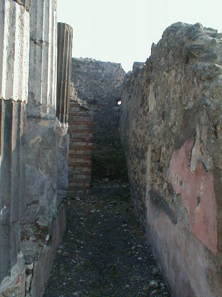 VI.9.3 Pompeii. September 2004. Looking east along narrow south portico of area 9, towards doorway to room 13.
