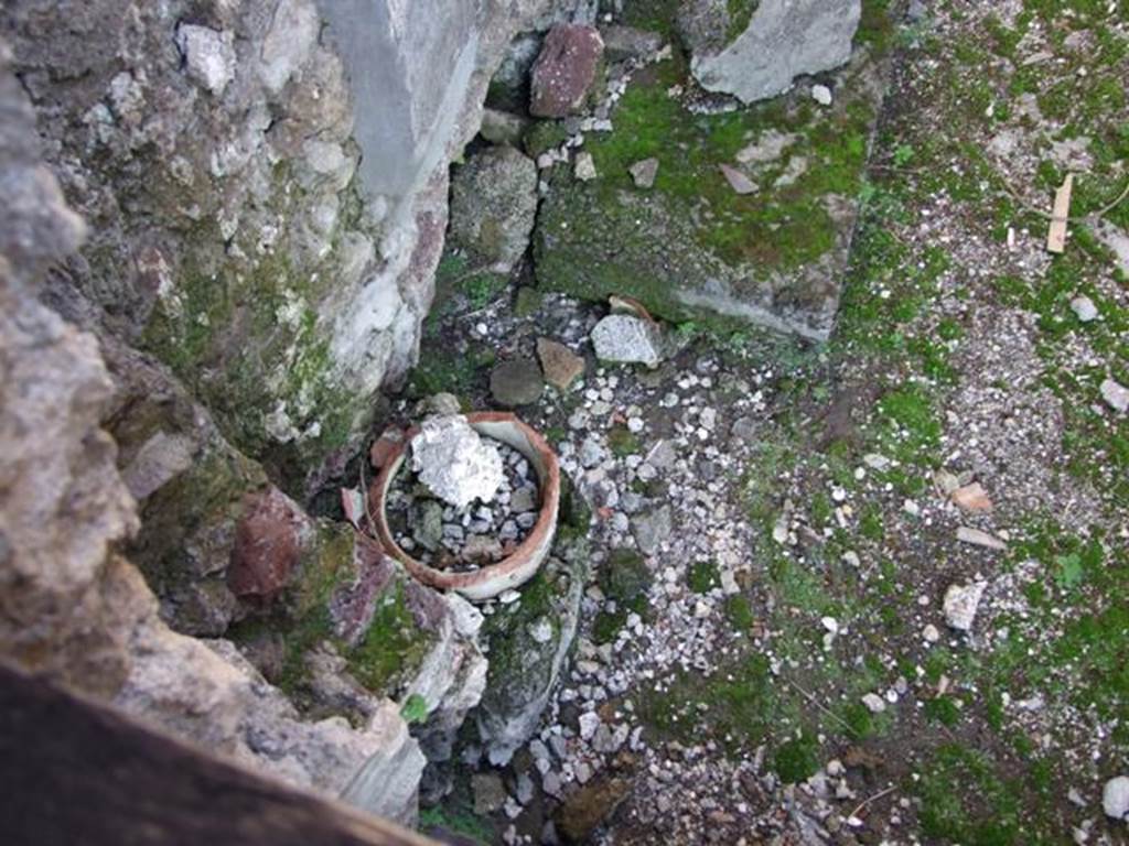 VI.9.4 Pompeii. December 2007. Remains of a terracotta down-pipe from the upper floor rooms in north-west corner of room15  below.