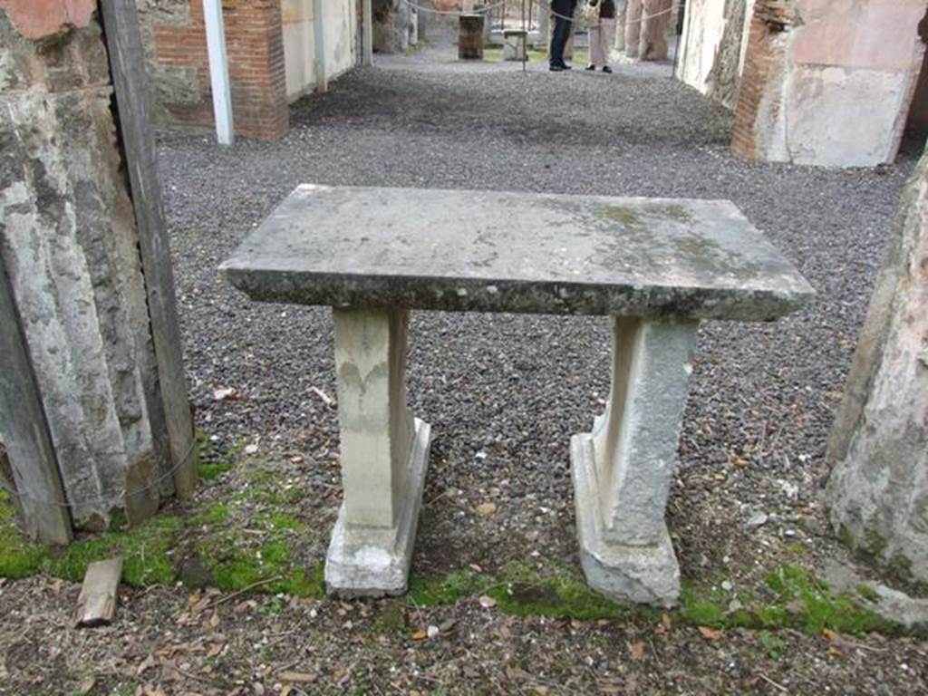 VI.9.6 Pompeii. March 2009. Room 17, rear of marble table in garden area. Looking west across portico and tablinum to front of house.

