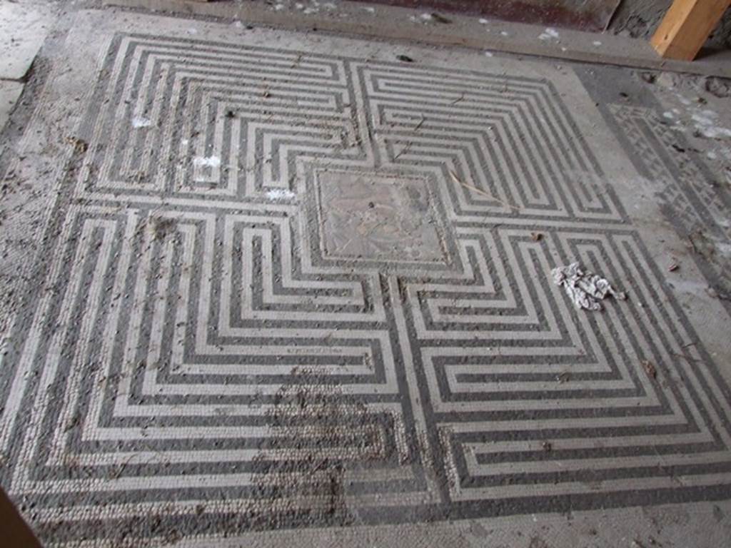 VI.11.10 Pompeii. December 2006. Room 42, labyrinth mosaic on floor of exedra.
According to Fiorelli, in PAH, vol. II, 1819-1860; 
9th September 1835  we are working to clear out the earth that covered all the floorings of the peristyle of the house of the private Baths, where in the floor of one of the rooms at the head of the same was revealed a small square of mosaic showing Theseus having killed the Minotaur, sized 17.25 inches squared (0.44m squared) (pal. 1 2/3 in quadro).
