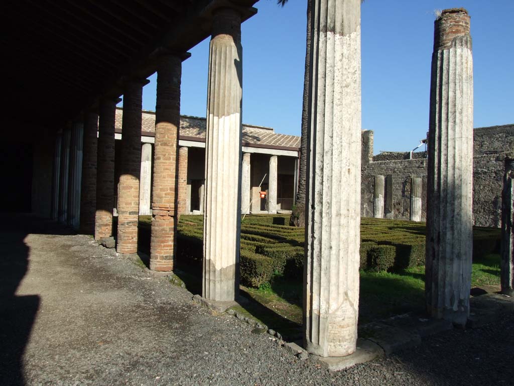VI.11.10 Pompeii. December 2007. Peristyle 36, looking north-east across peristyle from south-west corner.
West colonnade of peristyle showing brick columns, these had still not been redecorated in AD79 since the earthquake of AD62.