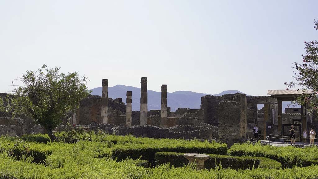 VI.12.2 Pompeii. August 2021. 
Looking south-east across peristyle garden towards VI.12.5, on left, atrium and entrance of VI.12.2, on right. Photo courtesy of Robert Hanson.
