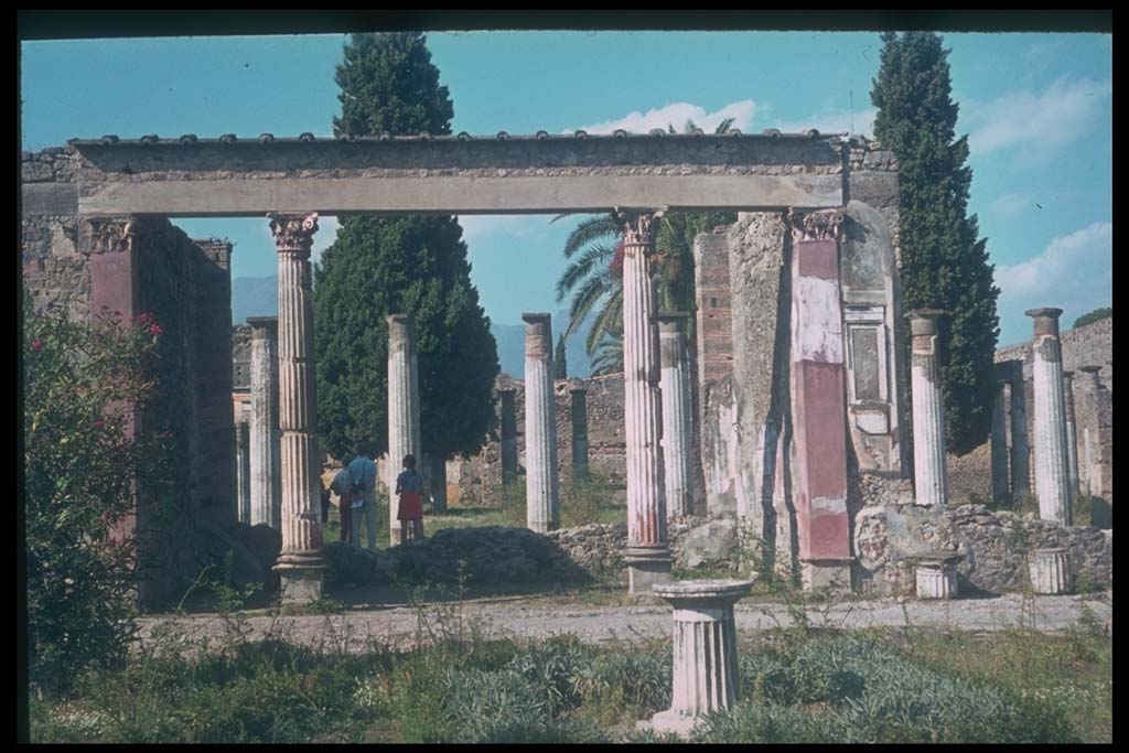 VI.12.2 Pompeii. Looking north from first garden across exedra to rear peristyle.
Photographed 1970-79 by Günther Einhorn, picture courtesy of his son Ralf Einhorn.
