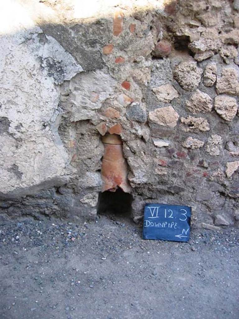 VI.12.3 Pompeii. July 2008. Downpipe in east wall of shop. Photo courtesy of Barry Hobson.