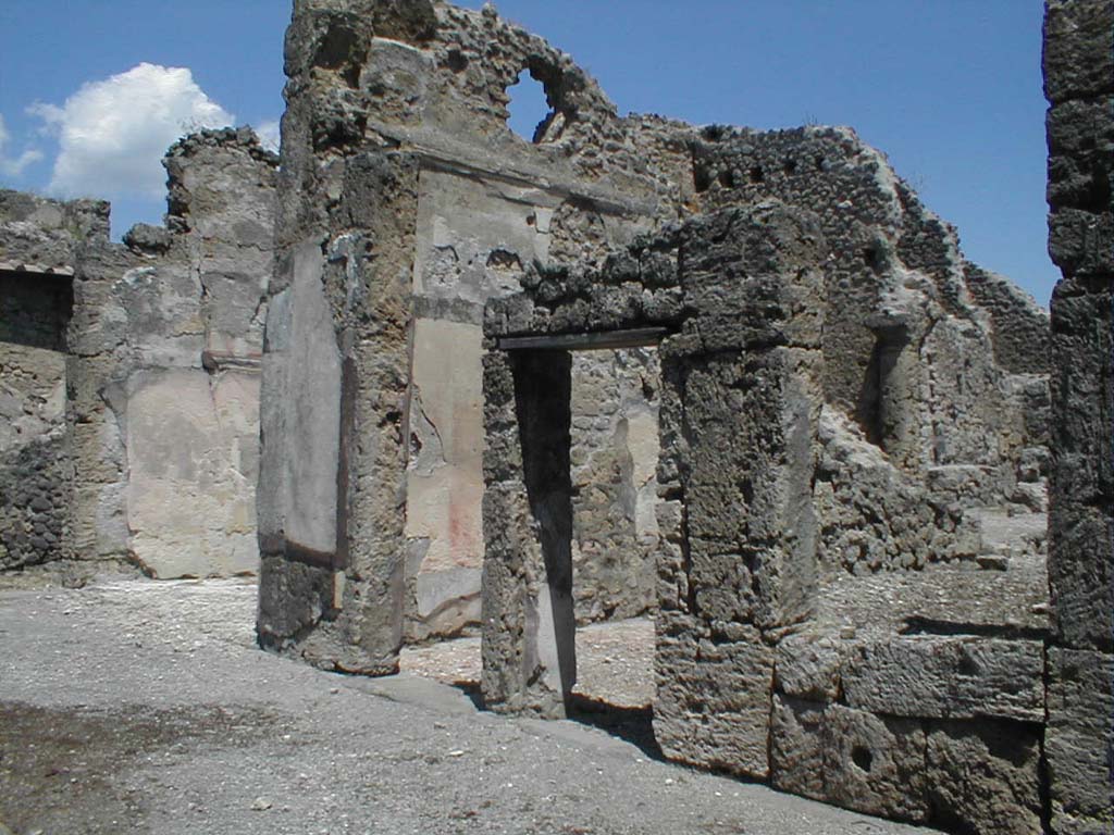 VI.14.12 Pompeii. May 2005.
Rooms on east side of atrium. On the left, the doorway to the winter triclinium, the east ala, and then two doorways to cubicula.