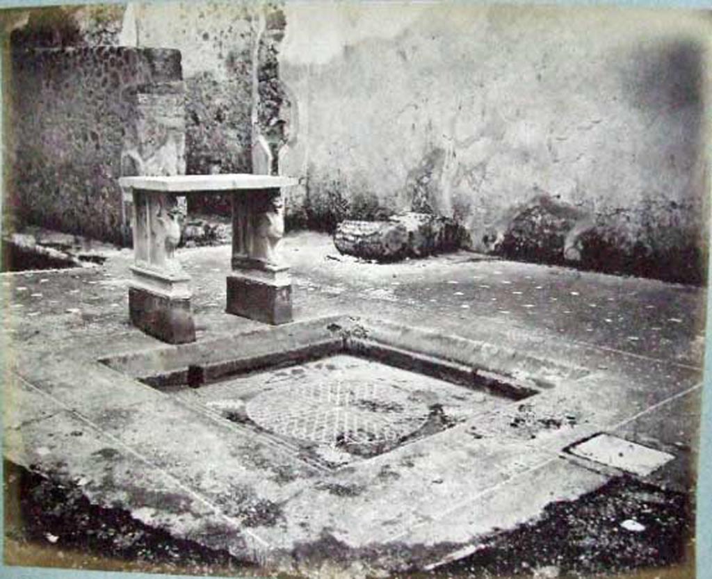 VI.14.39 Pompeii. Casa Lucrum Gaudium or Officina di tornitore. 
Looking south-east across atrium and tablinum, showing how it looked before bombing in 1943.
Old undated photograph courtesy of the Society of Antiquaries, Fox Collection.

According to Mau in BdI, the floor of the atrium was made of opus Signinum with crushed lava.
Near to the impluvium was a vent covered by a piece of square stone.
The rim of the impluvium was made of the same opus Signinum as the atrium floor, but with white stones.
In the front rim, between a line of white stones that surrounded it, one could read in letters not very regular, the words – LVCRVM GAVDIVM
At the rear were the two table legs, supported on a brick base which was painted red (0.25 high).
The base of each leg was marble and shaped like a griffin with a lion’s head.
See Mau in Bullettino dell’Instituto di Corrispondenza Archeologica (DAIR), 1878, (p.90).
