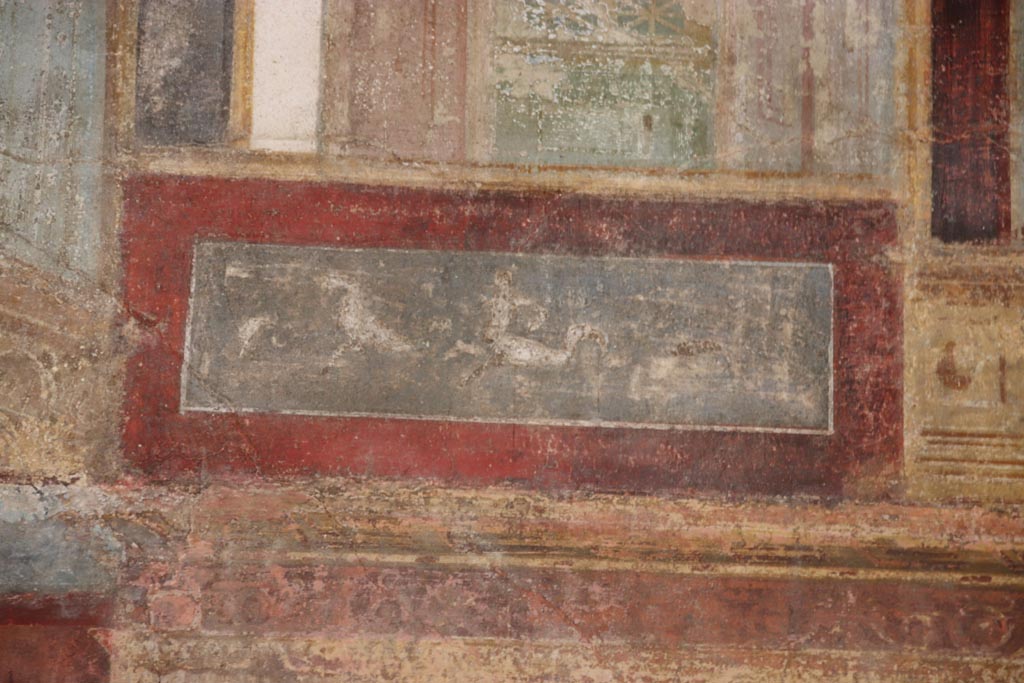 VI.15.1 Pompeii. October 2023. 
Upper east wall of exedra, continuation from north end, detail of painted panel. Photo courtesy of Klaus Heese.
