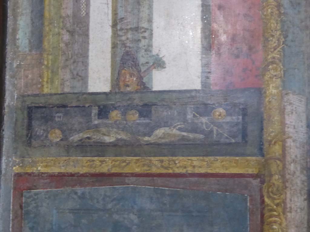 VI.15.1 Pompeii. March 2023. 
Detail of painted decoration below central painting on south wall of exedra. Photo courtesy of Johannes Eber.
