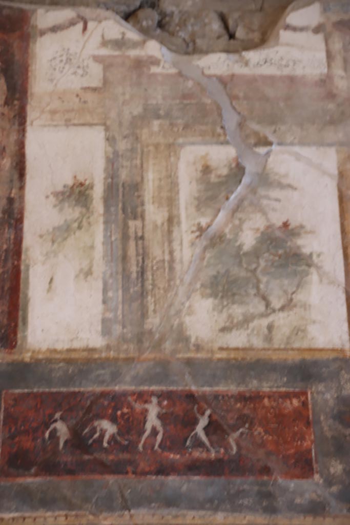 VI.15.1 Pompeii. October 2023. 
Upper south wall, painted decoration with panel below, on east side of central figure.
Photo courtesy of Klaus Heese.
