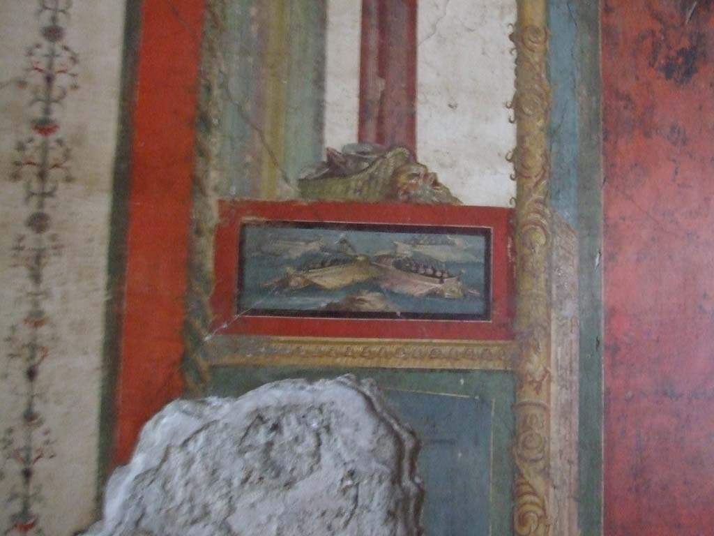 VI.15.1 Pompeii. December 2006. 
South wall of exedra with wall painting of naval scene on east side of central painting, with basket and mask above.
