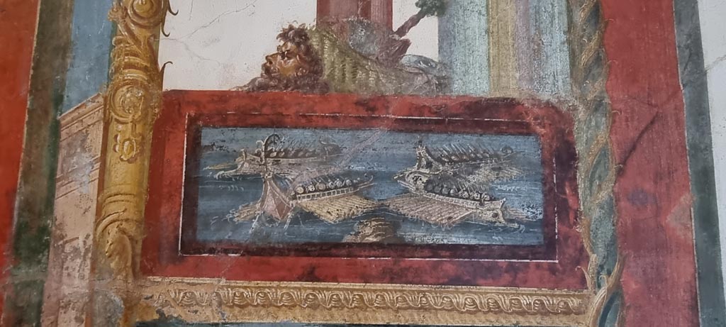 VI.15.1 Pompeii. January 2023. 
Painted panel of naval scene on west side of central painting on south wall. Photo courtesy of Miriam Colomer.
