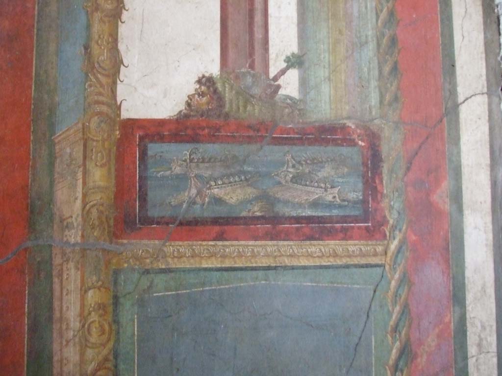 VI.15.1 Pompeii. December 2006. South wall of exedra with wall painting of naval scene, with basket and mask above.