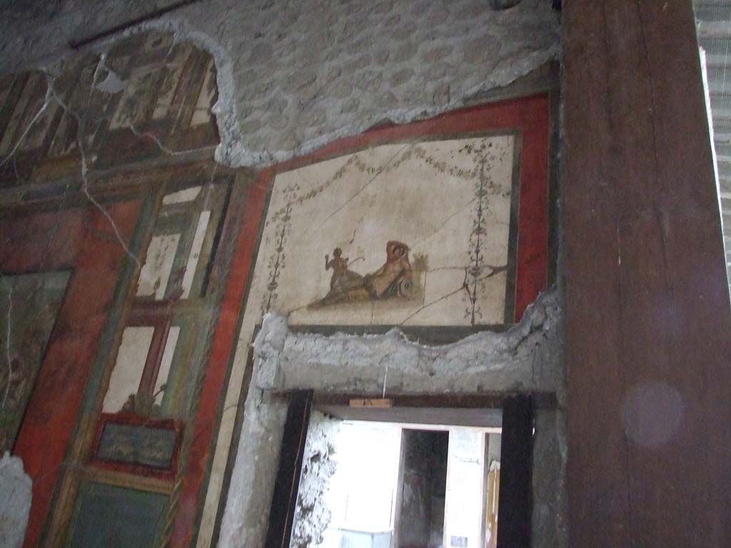 VI.15.1 Pompeii. December 2006. Painting of reclining figure over door of south wall of exedra.