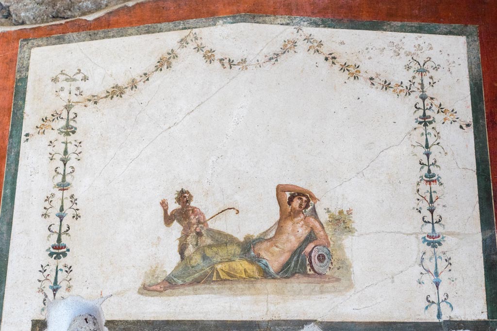 VI.15.1 Pompeii. March 2023. 
Painting of Pan discovering Hermaphrodite over door in south wall of exedra. Photo courtesy of Johannes Eber.
