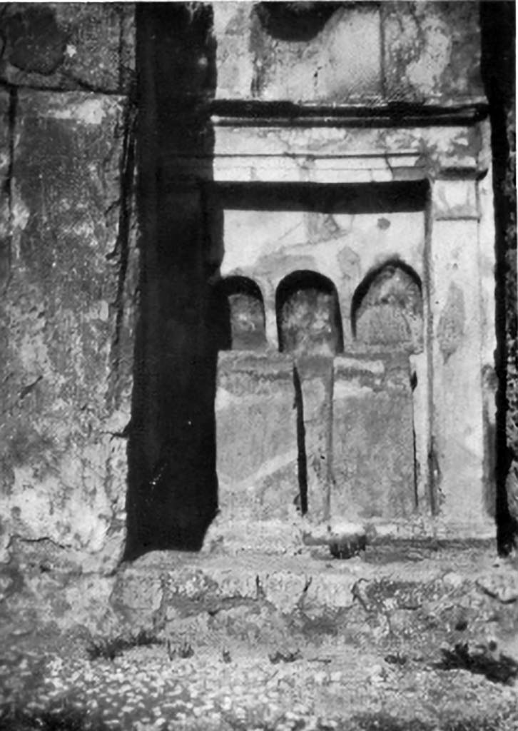 VI.15.5 Pompeii. 1930s photo by Tatiana Warscher. Room 1, atrium.    
Altar on east wall of the atrium composed of three arched niches, all of different sizes, and all three painted in red on the inside.
See Boyce G. K., 1937. Corpus of the Lararia of Pompeii. Rome: MAAR 14. (p. 54-5, no.212, with Pl. 40, 1)  
