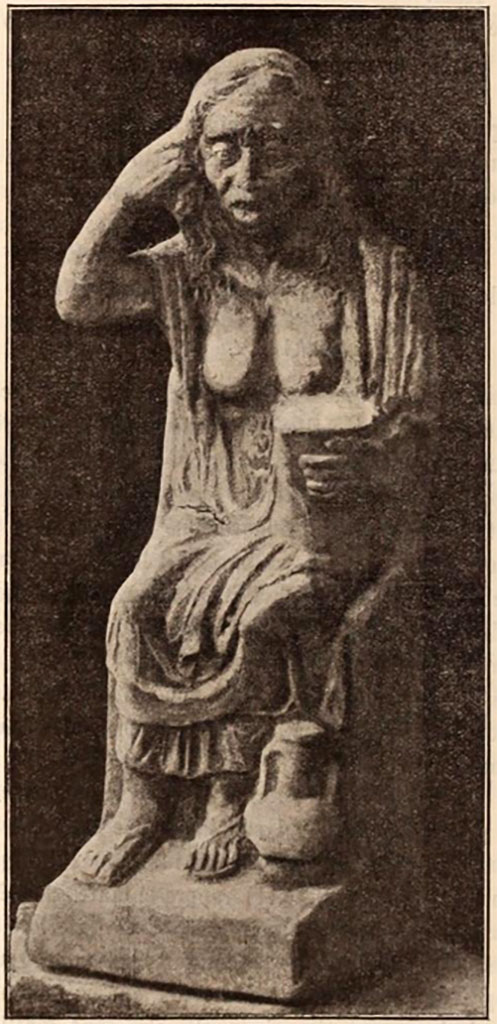 VI.15.5 Pompeii. Clay figurine of an old drunken woman, 0.41m high incl. base.
The statuette served as a jug for liquid, as could be seen by the ribbon handle, now broken, that was attached at the shoulders.
The hole for the liquid was seen between the neck and the top of the handle.
See Notizie degli Scavi di Antichità, 1897, p.24, fig. 2.
It was found in October 1895 in or near the garden niche, together with a group of other objects.
See Notizie degli Scavi di Antichità, 1895, p.438.
According to Jashemski, the jug is now in the Naples Archaeological Museum, inventory number 124844, Ruesch 442.
Other objects found nearby included –
Marble fountain statue of a Nymph, Naples inventory number: 124841.
A little vase in the shape of a Silenus, Naples inventory number: 124847.
A little vase in the shape of a Cock.
Two small vessels in the forms of Ducks and another in the shape of a Goose.
Two Bacchic masks were also found in the garden.
See Jashemski, W. F., 1993. The Gardens of Pompeii, Volume II: Appendices. New York: Caratzas. (p.155)
