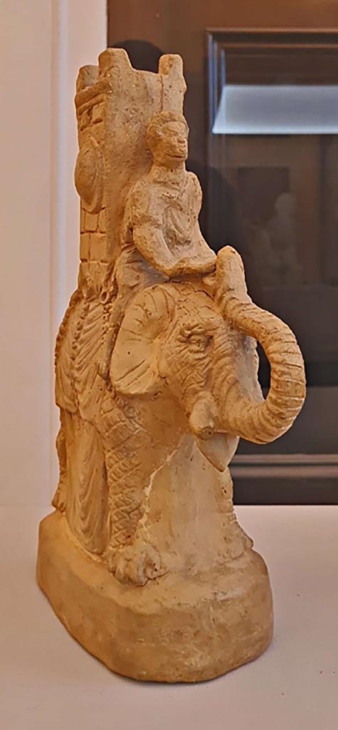 VI.15.5 Pompeii. October 2023. 
Clay figurine of an elephant carrying a tower on its back. 
Photo courtesy of Giuseppe Ciaramella. 
On display in “L’altra MANN” exhibition, October 2023, at Naples Archaeological Museum.
