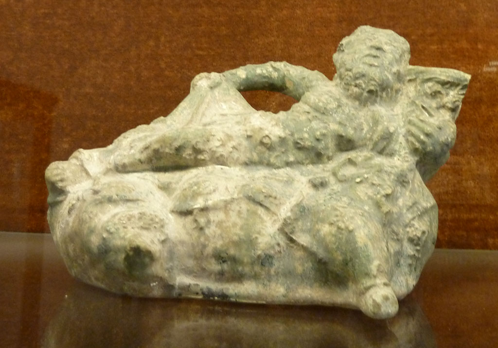 VI.15.5 Pompeii. April 2019. Statuette of Silenus, found on west side of garden near the aedicula.
Photo courtesy of Rick Bauer.
Now in Naples Archaeological Museum, inventory no. 124847.
Sala (room) 88, glass cabinet V, shelf C (top).
See Di Gioia, E. (2006). La ceramica invetriata in area vesuviana. “L’Erma” di Bretschneider, (p.122-23).

