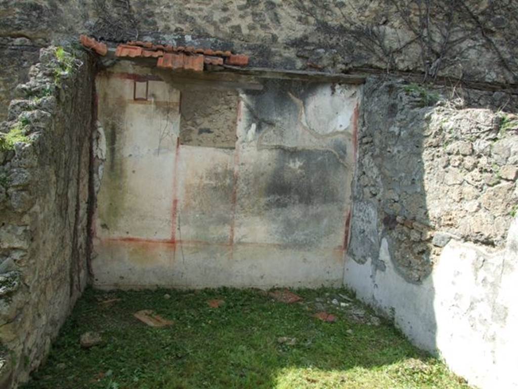 VI.15.5 Pompeii. March 2009. Room 22, west wall. According to NdS, this room was decorated with panels with a white background. On the west wall was a painting (0.38m high x 0.32 wide) of the noted representation of Narcissus looking into a pool. The painting was shown with two open door shutters, which looked as if they could close. In the side panels on the same west wall were painted groups of flying cupids (0.29m high). The one on the right showed two embracing cupids of which one of them was holding a rhyton (a vase in the shape of a horn)  high in the left hand. The liquid was flowing from it into a patera or dish, which the other was holding in the right hand. The second group in the panel on the left represented Eros and Psyche kissing. In the west wall, above the painting of Narcissus, was a small window, which was walled-up by the ancients themselves. See Notizie degli Scavi, January 1897, (p.29-30)
