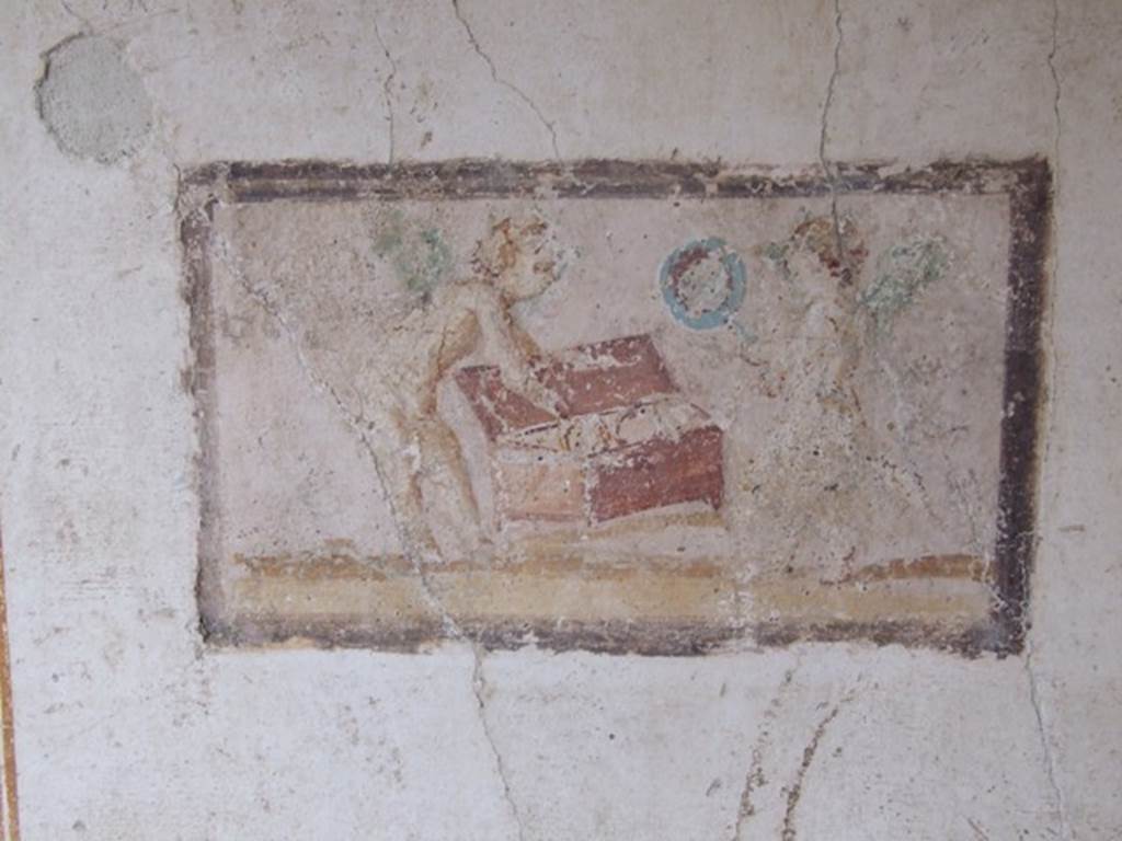 VI.15.8 Pompeii. December 2007. East wall of summer triclinium showing panel with cupids and a chest.